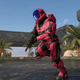 A spartan in red armor runs on the Behemoth level in Halo Infinite.
